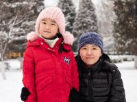 Little Girl And Mother In Snow